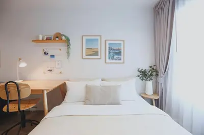 a small bedroom with a bed and a desk at Minimal Cozy Room near Chatuchak Weekend Market #2 in Bangkok