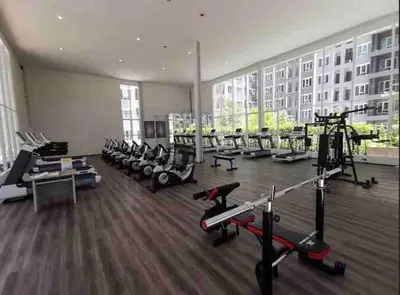 a gym with a bunch of treadmills and machines at Minimal Cozy Room near Chatuchak Weekend Market #2 in Bangkok