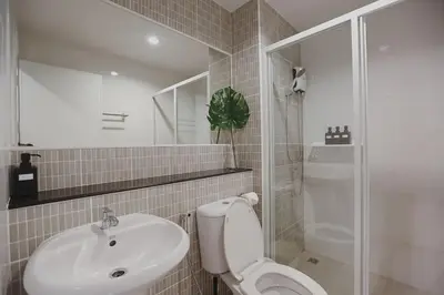 a bathroom with a toilet and a sink and a shower at Minimal Cozy Room near Chatuchak Weekend Market #2 in Bangkok