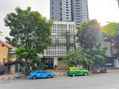 three cars parked on a street in front of a building at Silom Nara in Bangkok