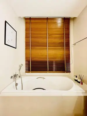 a white bath tub in a bathroom with a window at Luxury 2BR on the Clouds in Prime area Bangkok in Bangkok