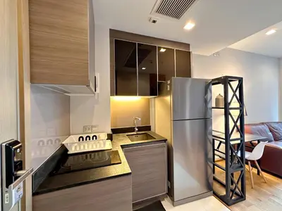 a kitchen with a stainless steel refrigerator in a room at 1BR Luxury Condo 50m to Thonglor BTS station in Bangkok