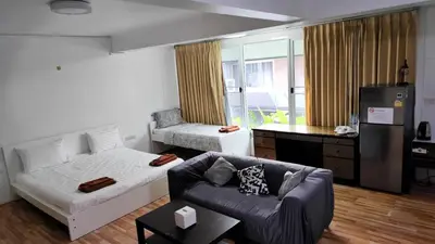a living room with a bed and a couch at Doodle Lodge Bangkok in Bangkok