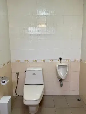a bathroom with a toilet and a urinal at Doodle Lodge Bangkok in Bangkok