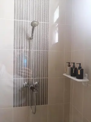 a shower with a shower head in a bathroom at AP HOUSE in Bangkok