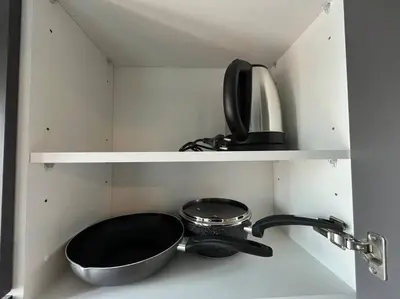 a kitchen with a sink and a bowl and a pan at Monte Rama 9 near JodFair Market in Bangkok