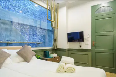 a bedroom with a bed with two towels on it at Ci home in Pom Prap