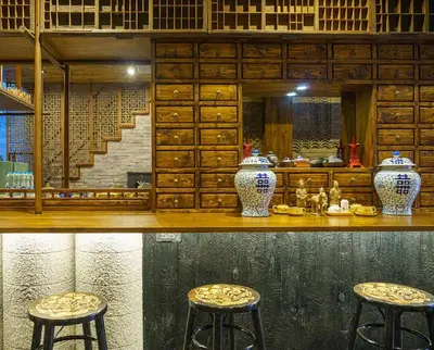 a counter with two stools and vases on it at Ci home in Pom Prap