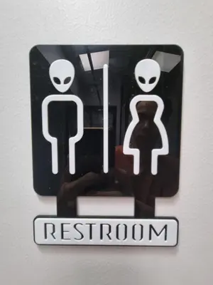 a restroom sign with two man and woman on it at Met A Space Pod @Phrom Phong in Bangkok