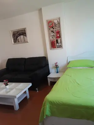 a bedroom with a green bed and a couch at T8impact Challenger Mueang Thon Thani Free WIFI in Nonthaburi