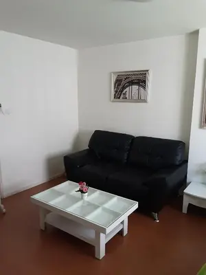 a living room with a black couch and a coffee table at T8impact Challenger Mueang Thon Thani Free WIFI in Nonthaburi