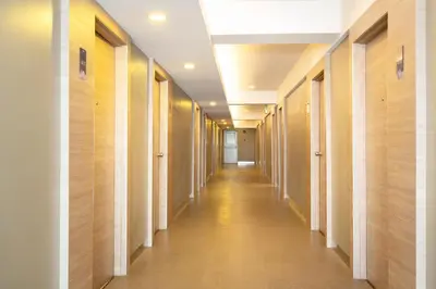 a hallway of a building with wooden walls and a long aisle at Synsiri Lat Phrao 83 in Ban Zong Katiam