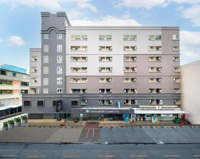a large building with a parking lot in front of it at Synsiri Lat Phrao 83 in Ban Zong Katiam