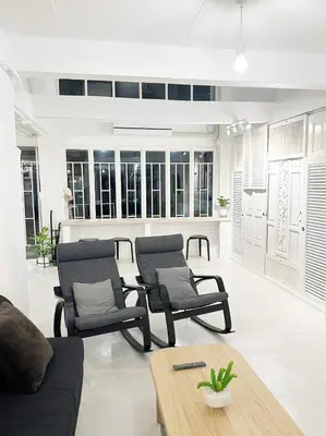 a living room with two chairs and a table at River Home Bangkok in Bangkok