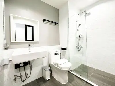 a bathroom with a toilet and a sink and a shower at River Home Bangkok in Bangkok