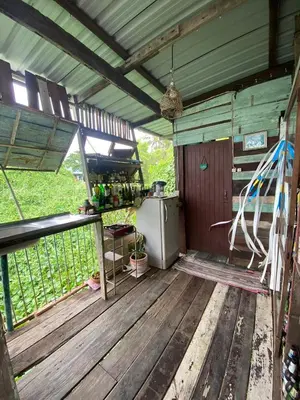 an inside view of an outdoor kitchen in a building at Baan GoLite Ko Kret - บ้านโกไล้เกาะเกร็ด in Nonthaburi