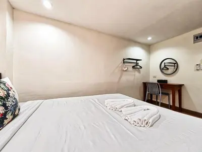 a bedroom with a bed with two towels on it at Bangkok Watergate Townhouse \u66fc\u8c37\u4e2d\u5fc3\u6c34\u9580\u5bb6 in Bangkok