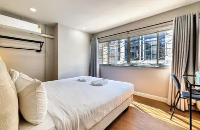 a bedroom with a bed and a window at Bangkok Watergate Townhouse \u66fc\u8c37\u4e2d\u5fc3\u6c34\u9580\u5bb6 in Bangkok