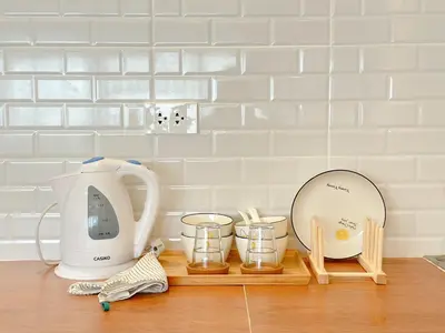 a counter with a tea kettle and other kitchen items on it at Happiness Sleep in Thung Si Kan