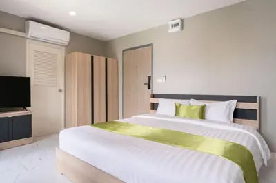 a bedroom with a large bed and a television at iCheck inn Darisa Ngamwongwan in Nonthaburi
