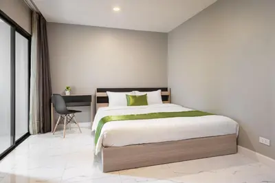 a bedroom with a large bed and a desk at iCheck inn Darisa Ngamwongwan in Nonthaburi