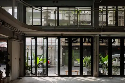 an entrance to a building with glass doors at C'HOUSE Bangkok in Pom Prap