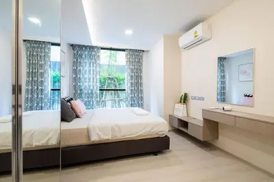 a bedroom with a large bed and a window at 1bed room bts thonglo SuperiorSpaApartment in Ban Chaliang Khok