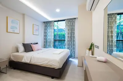 a bedroom with a bed and a large window at 1bed room bts thonglo SuperiorSpaApartment in Ban Chaliang Khok