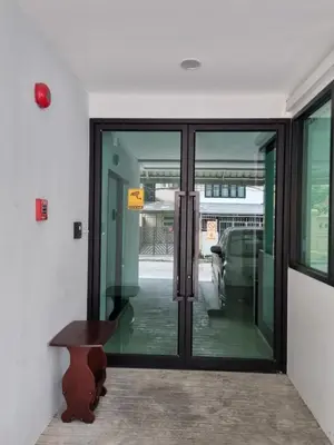 a glass door with a bench in front of it at Tiara Place in Bangkok